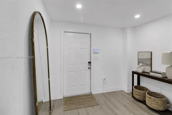 a view of room with furniture and wooden floor