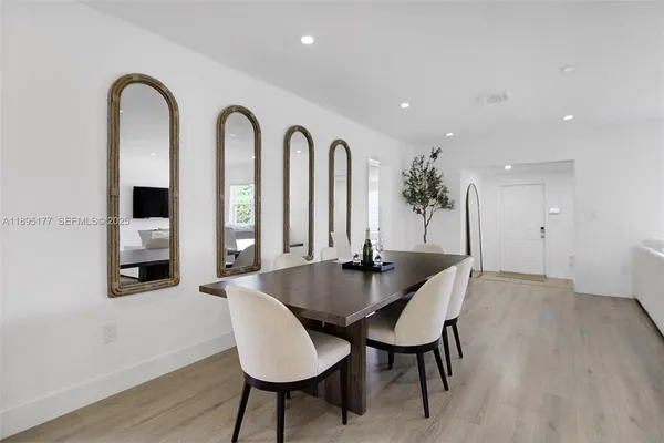 a dining room with furniture and window