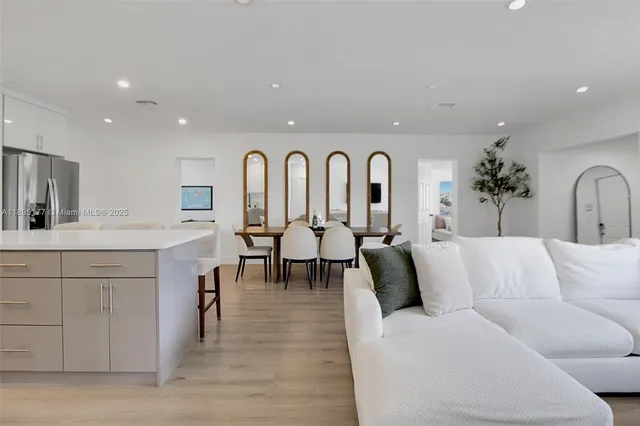 a living room with furniture a dining table and chairs