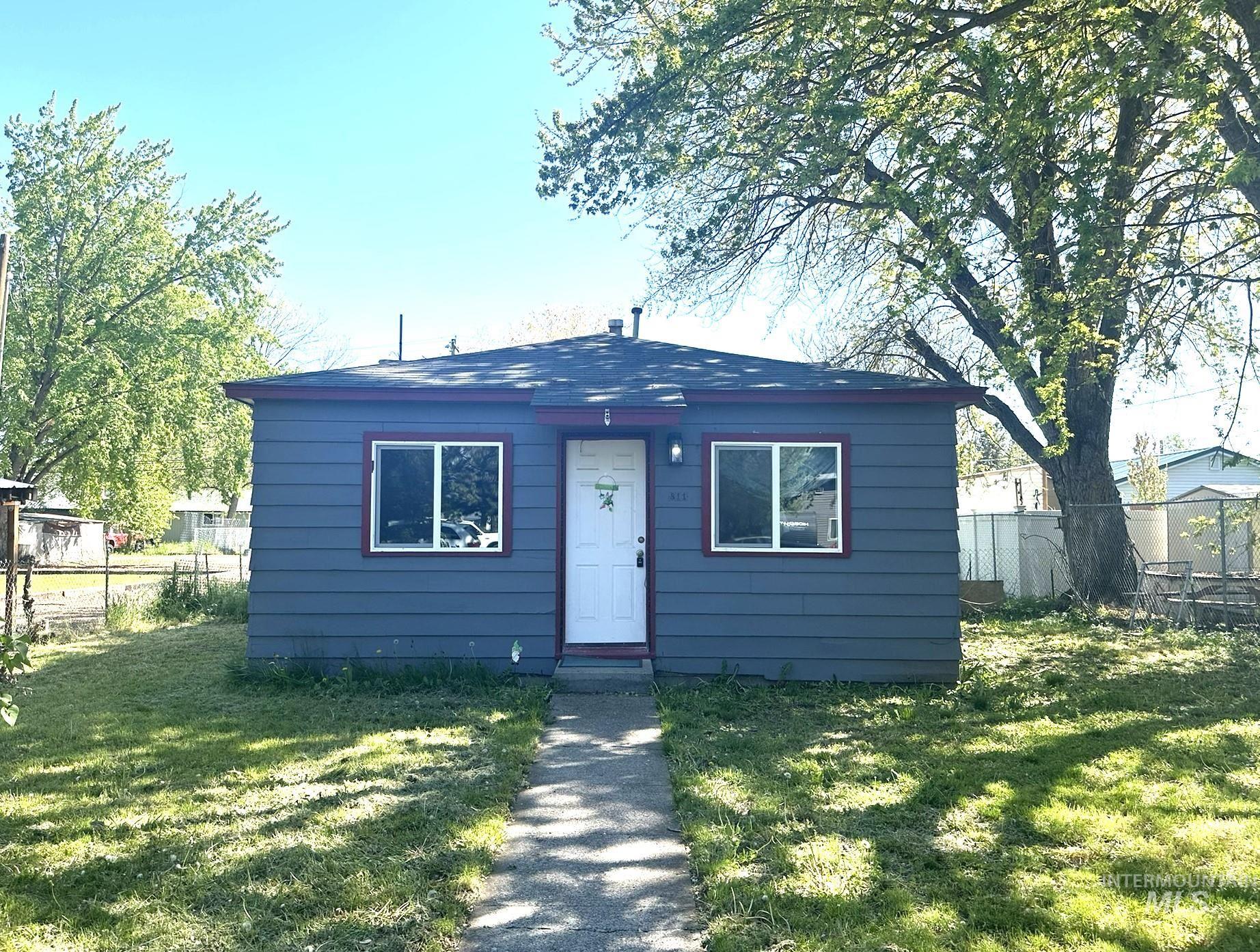 811 East Liberty Street Weiser, ID 83672 - Photo 1 of 12 Gray siding exterior with white trim windows and a white entry door