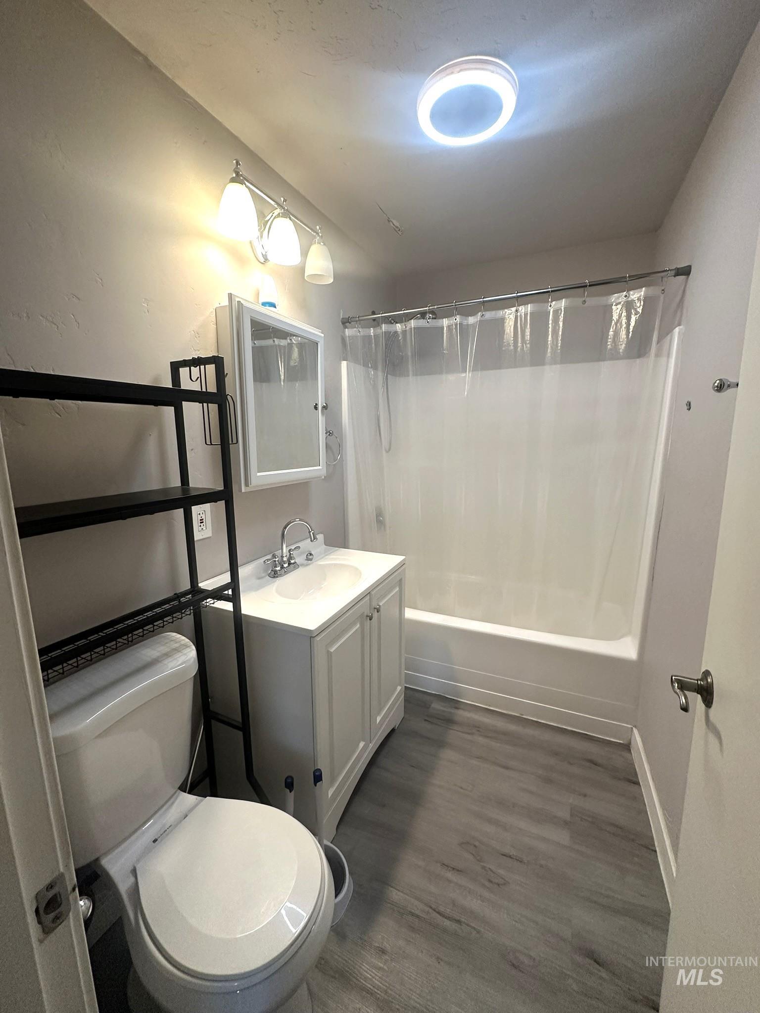 811 East Liberty Street Weiser, ID 83672 - Photo 6 of 12 Bathroom featuring vanity, shower / bath combo, and dark wood finished floors