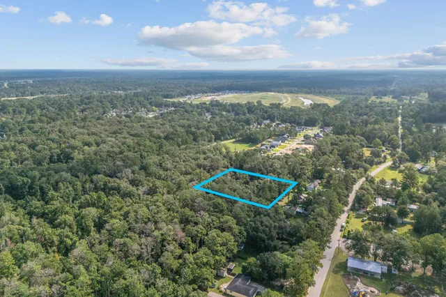 an aerial view of a city with lots of residential buildings and mountain view in back
