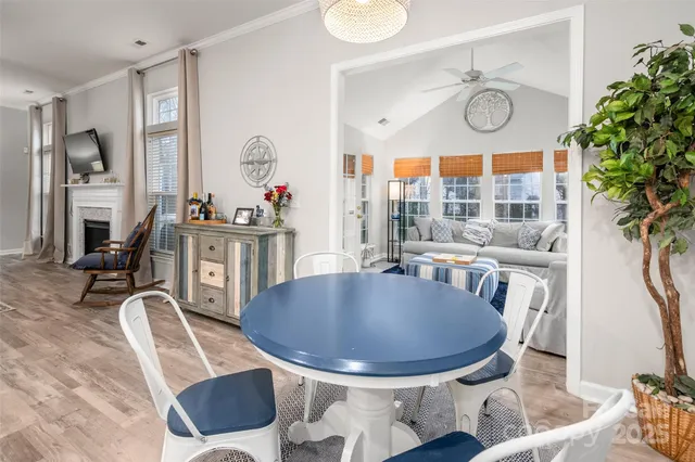 a dining room with furniture a rug and wooden floor