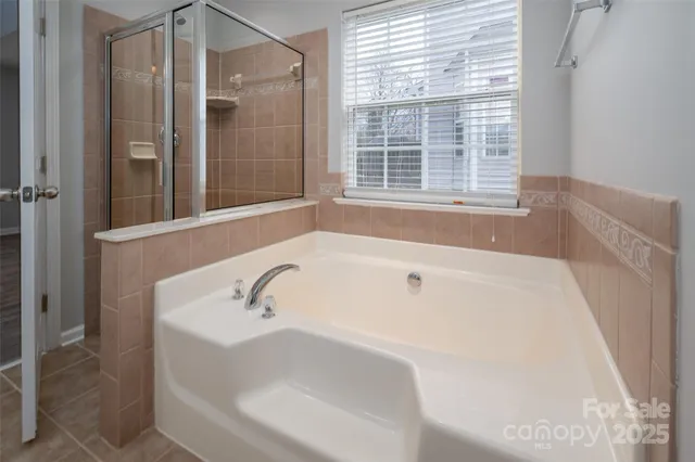 a bathroom with bathtub and window