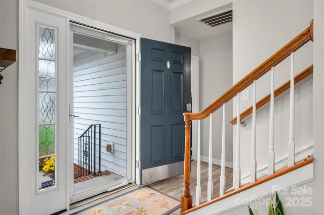 a view of staircase with wooden floor and a window