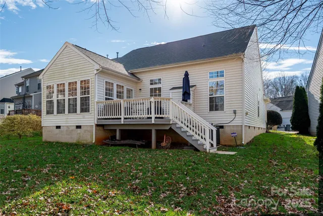 a view of a house with a yard and deck
