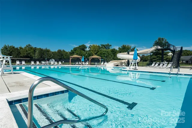 a view of swimming pool with a garden and seating area