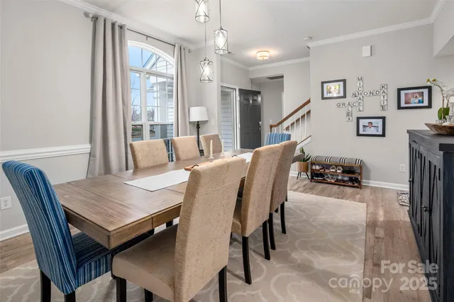 a view of a dining room with furniture large window and wooden floor