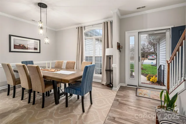 a view of a dining room with furniture and a potted plant
