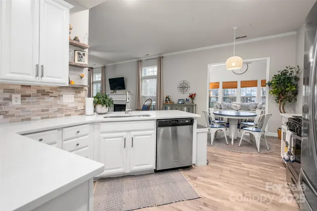 a kitchen with sink cabinets and dining table chair