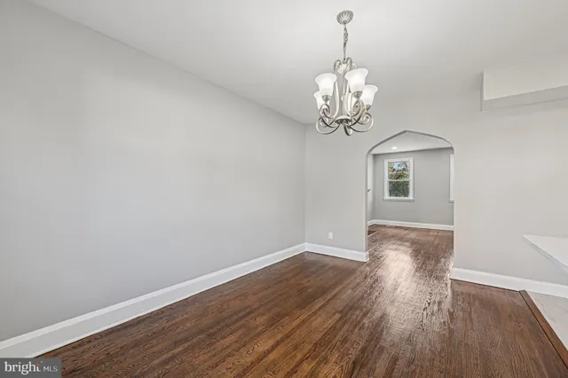 a view of a chandelier in a room and wooden floor