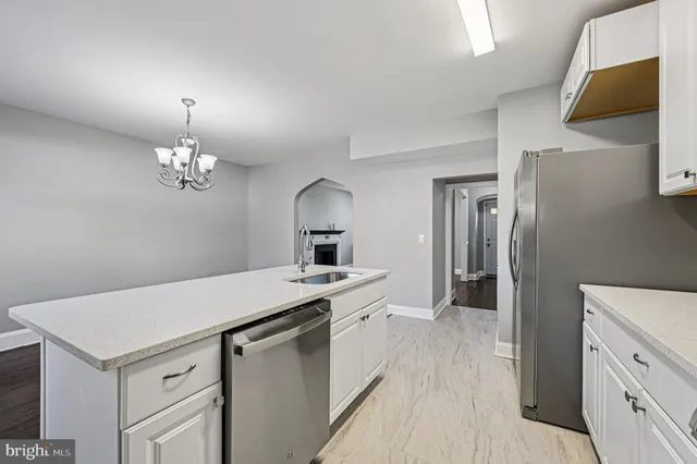 a kitchen with a sink appliances and cabinets