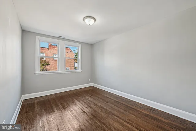 a view of room with window and hardwood floor