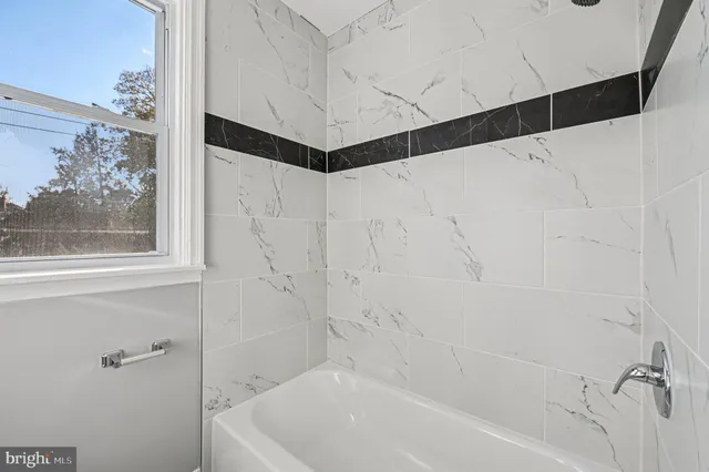 a bathroom with a bathtub and shower