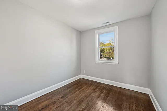 a room with a window and wooden floor
