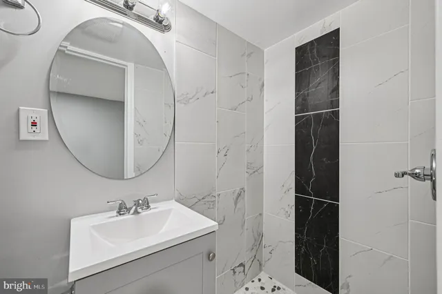 a view of a backyard with large trees and wooden fence