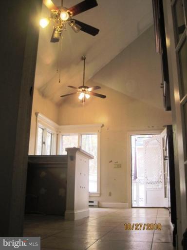 355 Rt 28 Berkeley Springs Berkeley Springs, WV 25411 - Photo 22 of 24 a view of a livingroom with a ceiling fan and window