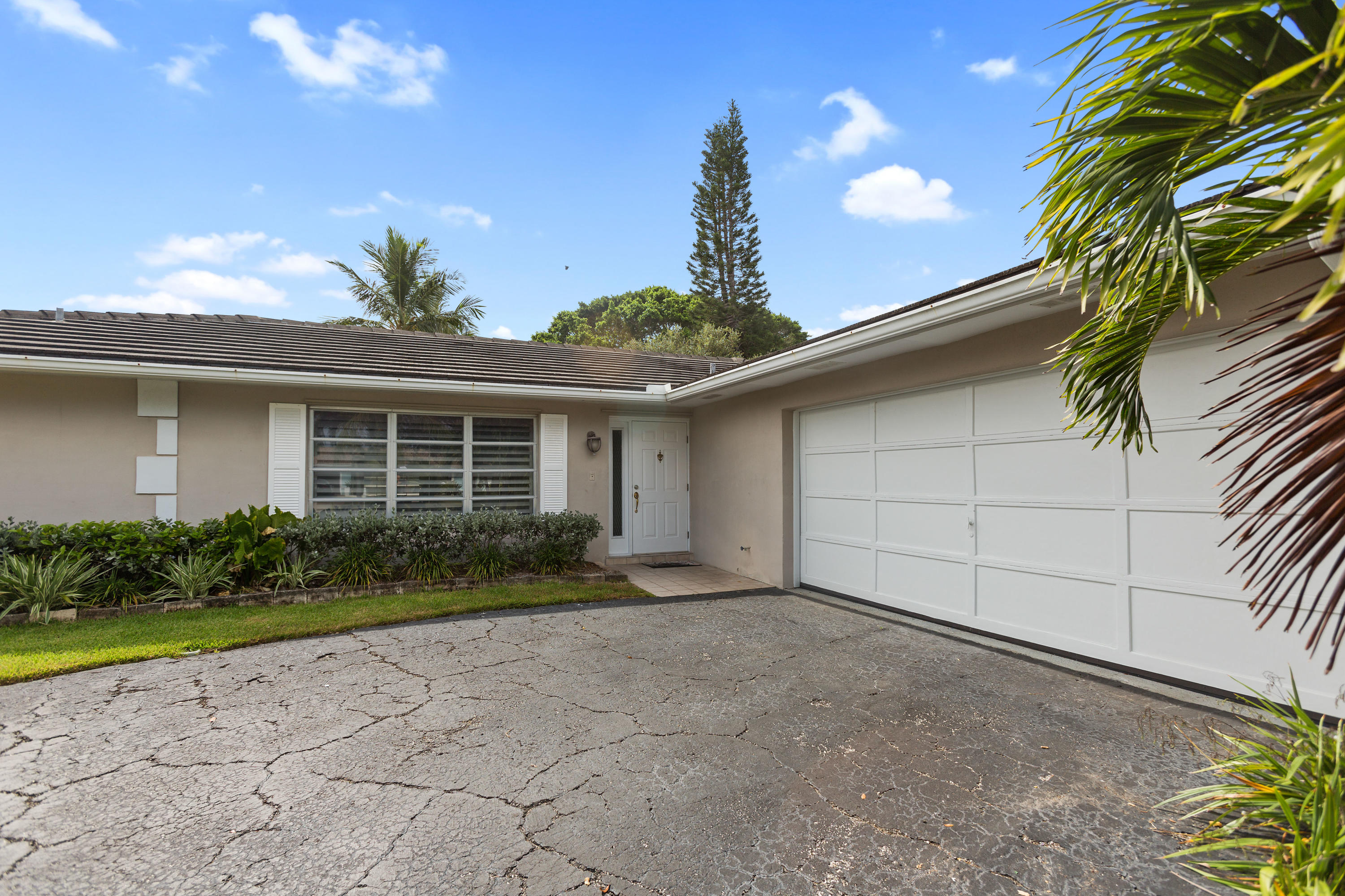 12705 Ellison Wilson Road North Palm Beach, FL 33408 - Photo 17 of 19 a front view of a house with garden