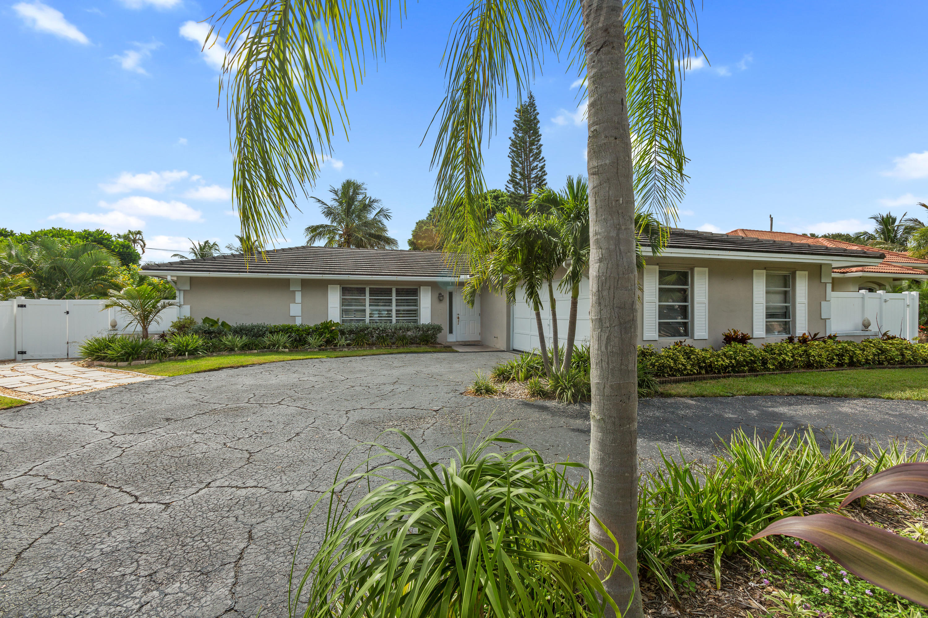 12705 Ellison Wilson Road North Palm Beach, FL 33408 - Photo 18 of 19 a front view of a house with a garden