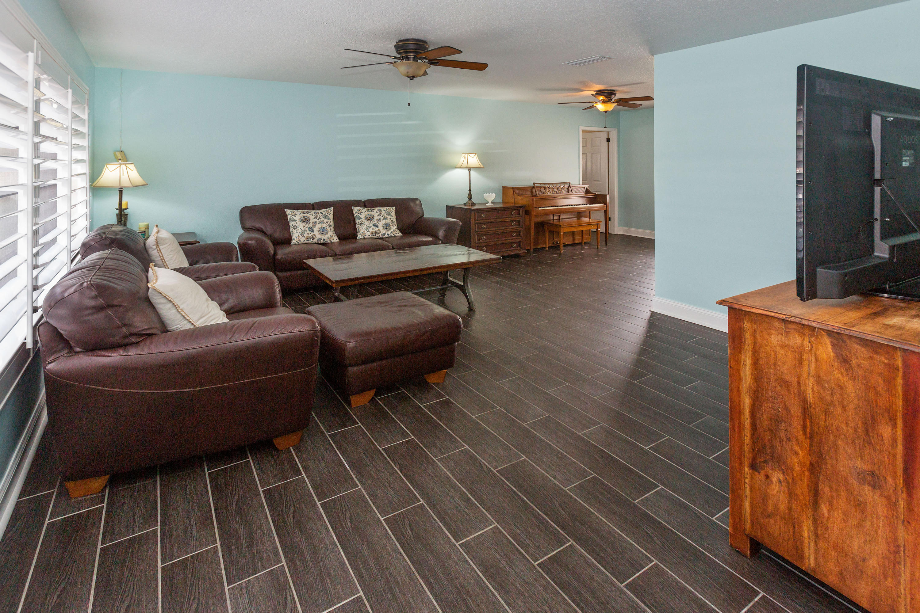 12705 Ellison Wilson Road North Palm Beach, FL 33408 - Photo 2 of 19 a living room with furniture and a flat screen tv