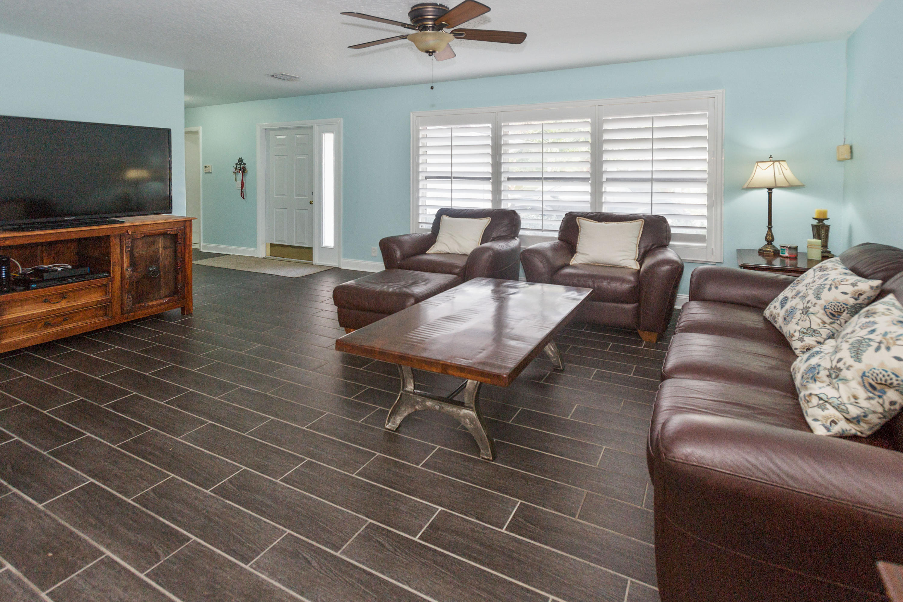 12705 Ellison Wilson Road North Palm Beach, FL 33408 - Photo 3 of 19 a living room with furniture and a flat screen tv