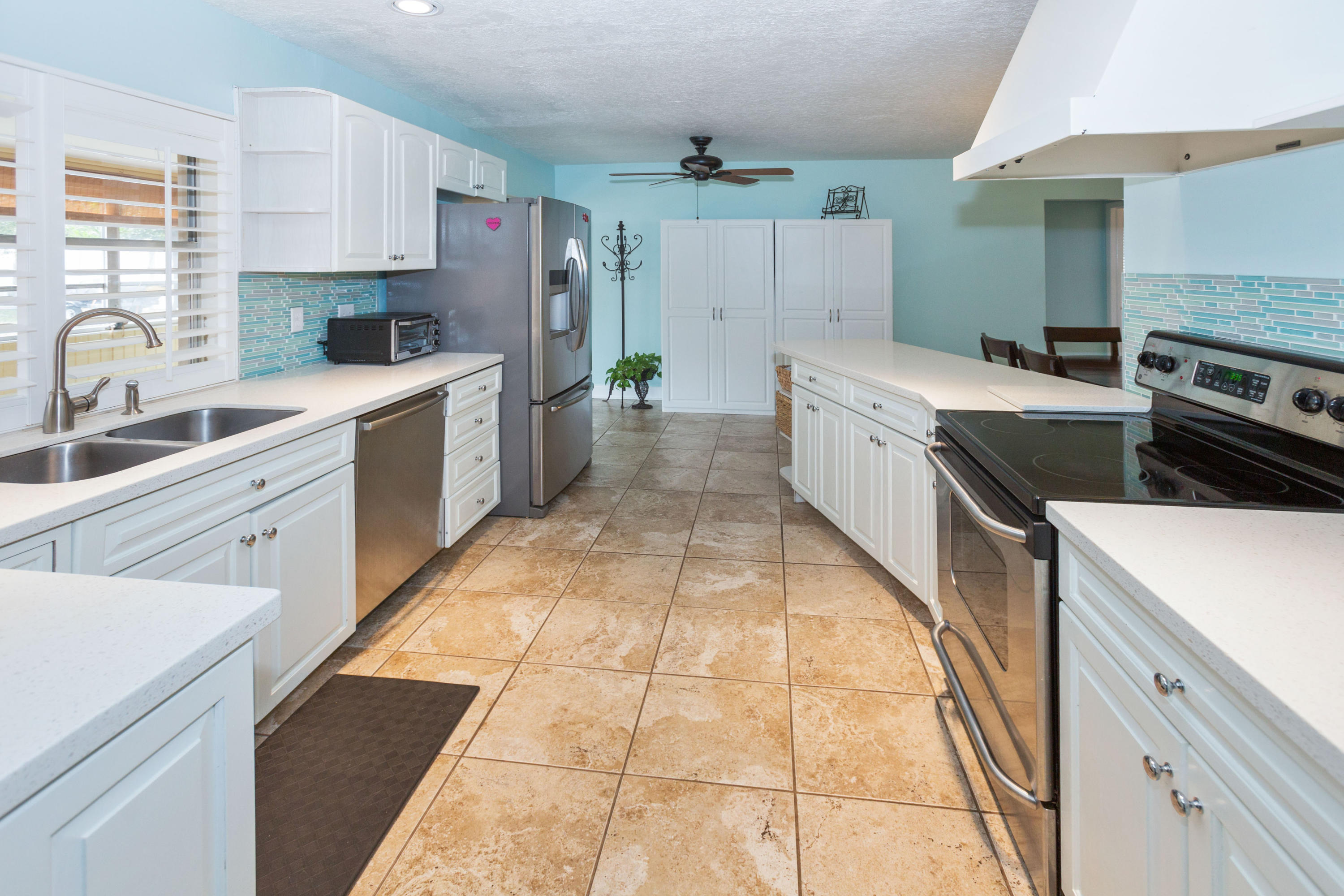 12705 Ellison Wilson Road North Palm Beach, FL 33408 - Photo 4 of 19 a kitchen with a stove sink and cabinets