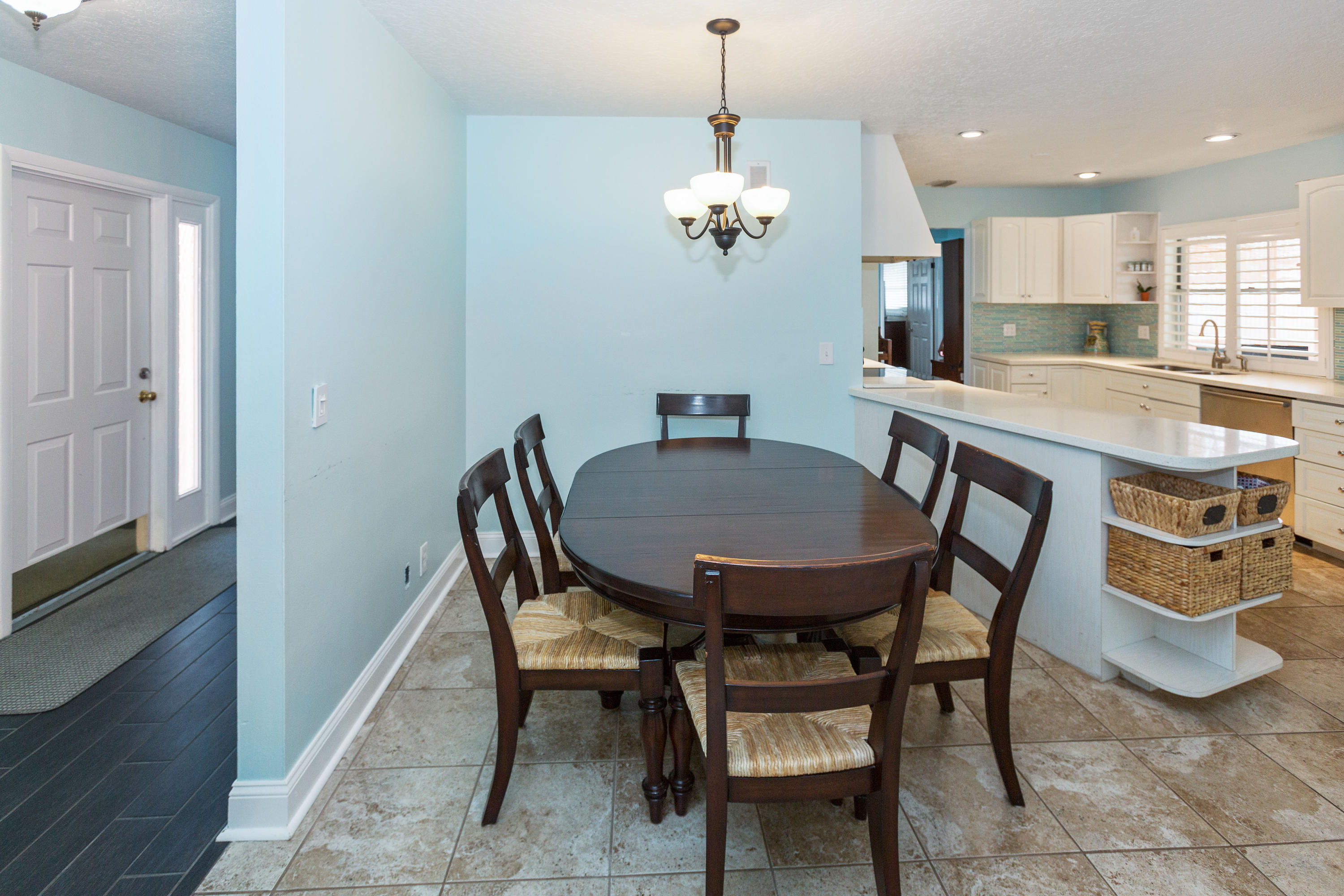 12705 Ellison Wilson Road North Palm Beach, FL 33408 - Photo 6 of 19 a view of a dining room with furniture and chandelier