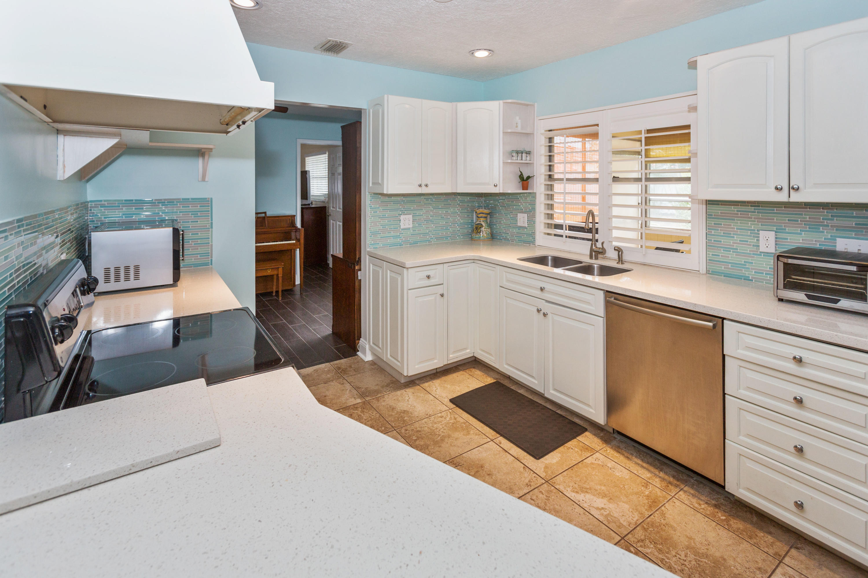 12705 Ellison Wilson Road North Palm Beach, FL 33408 - Photo 7 of 19 a kitchen with granite countertop cabinets stainless steel appliances a sink and a window