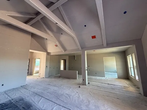 a view of a hallway with wooden floor and chandelier