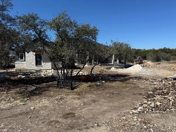 a side view of a house with a yard