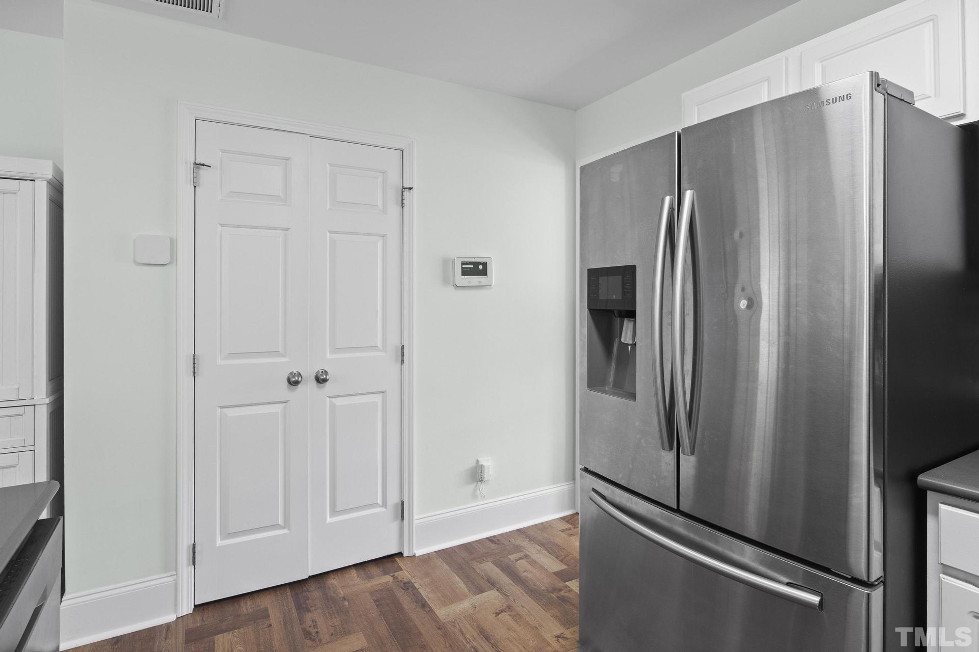 1727 Crag Burn Lane Raleigh, NC 27604 - Photo 11 of 43 a metallic refrigerator freezer sitting in a kitchen