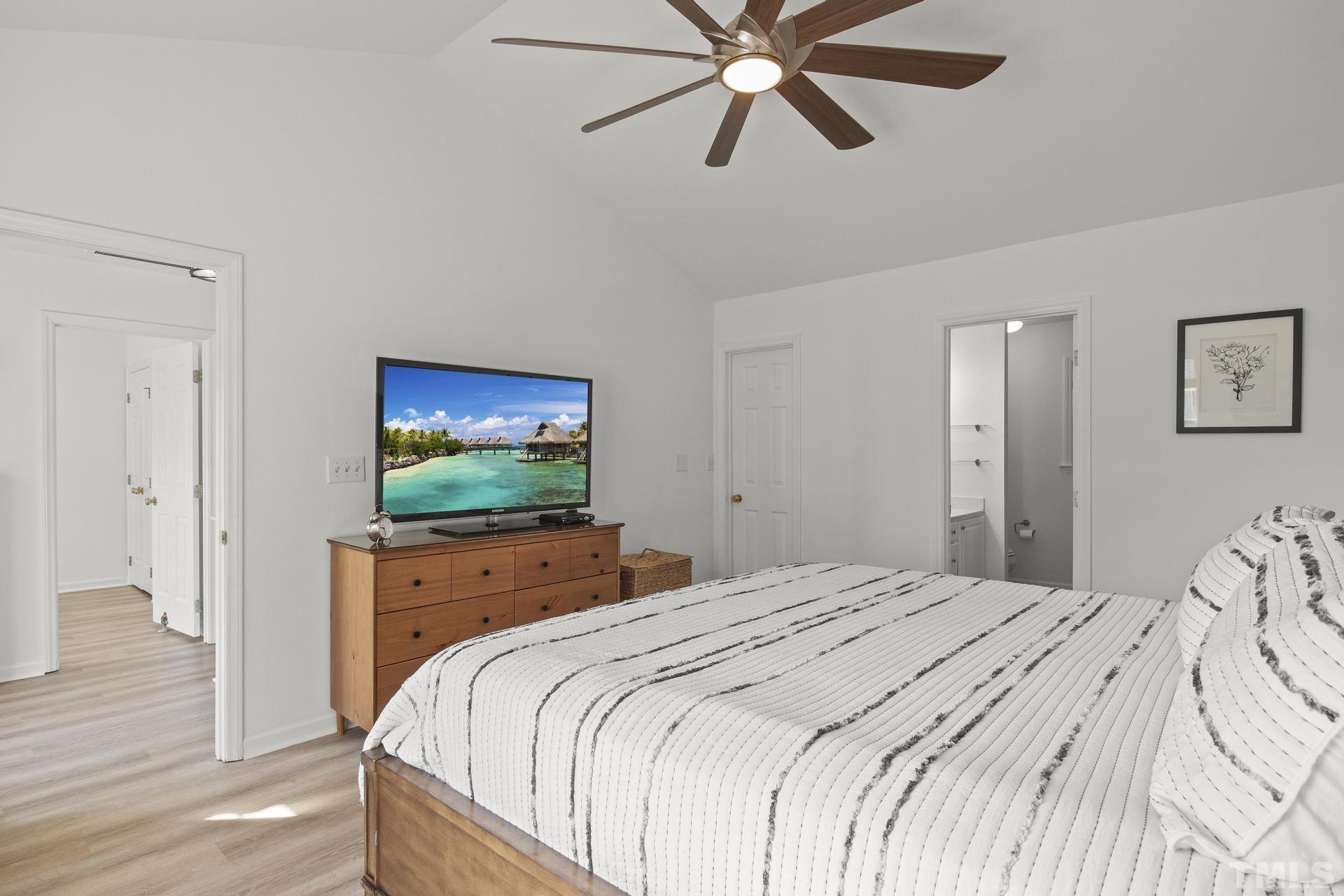 1727 Crag Burn Lane Raleigh, NC 27604 - Photo 17 of 43 a bedroom with a bed and a flat screen tv