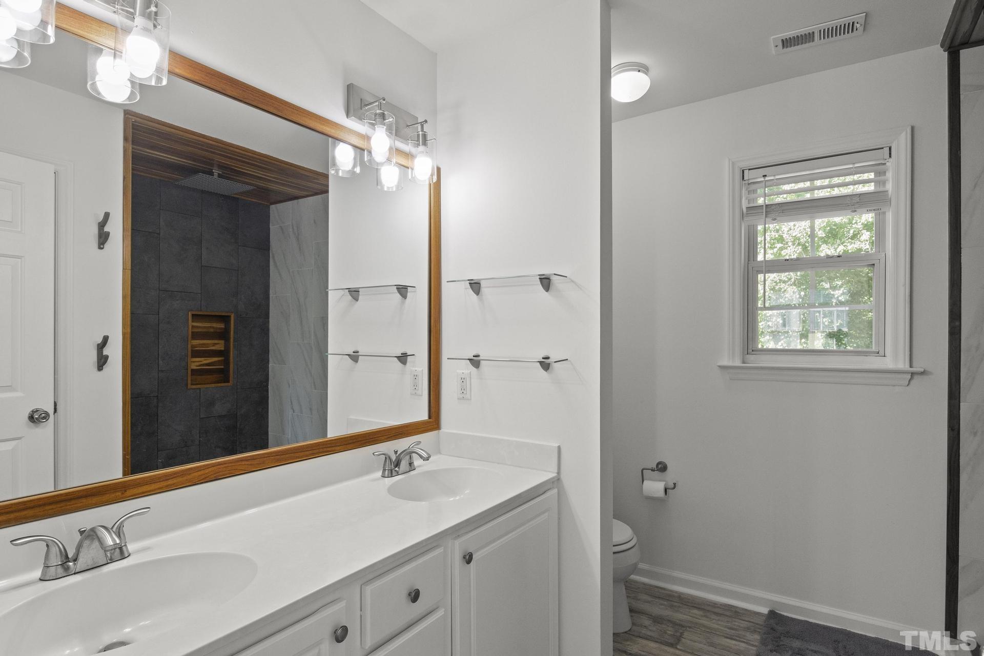 1727 Crag Burn Lane Raleigh, NC 27604 - Photo 19 of 43 a bathroom with a sink and a mirror