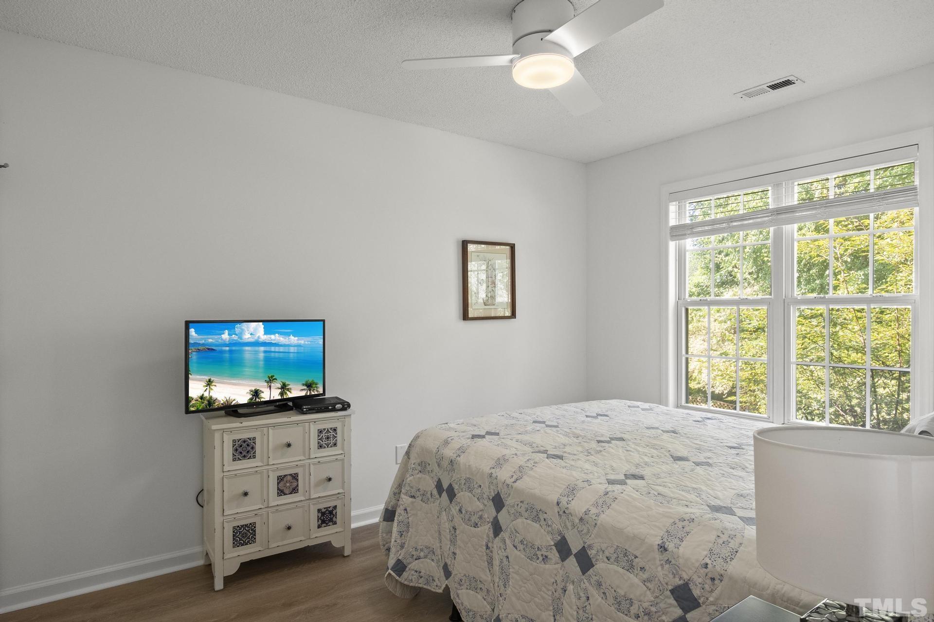 1727 Crag Burn Lane Raleigh, NC 27604 - Photo 24 of 43 a bedroom with a bed and a tv on the dresser