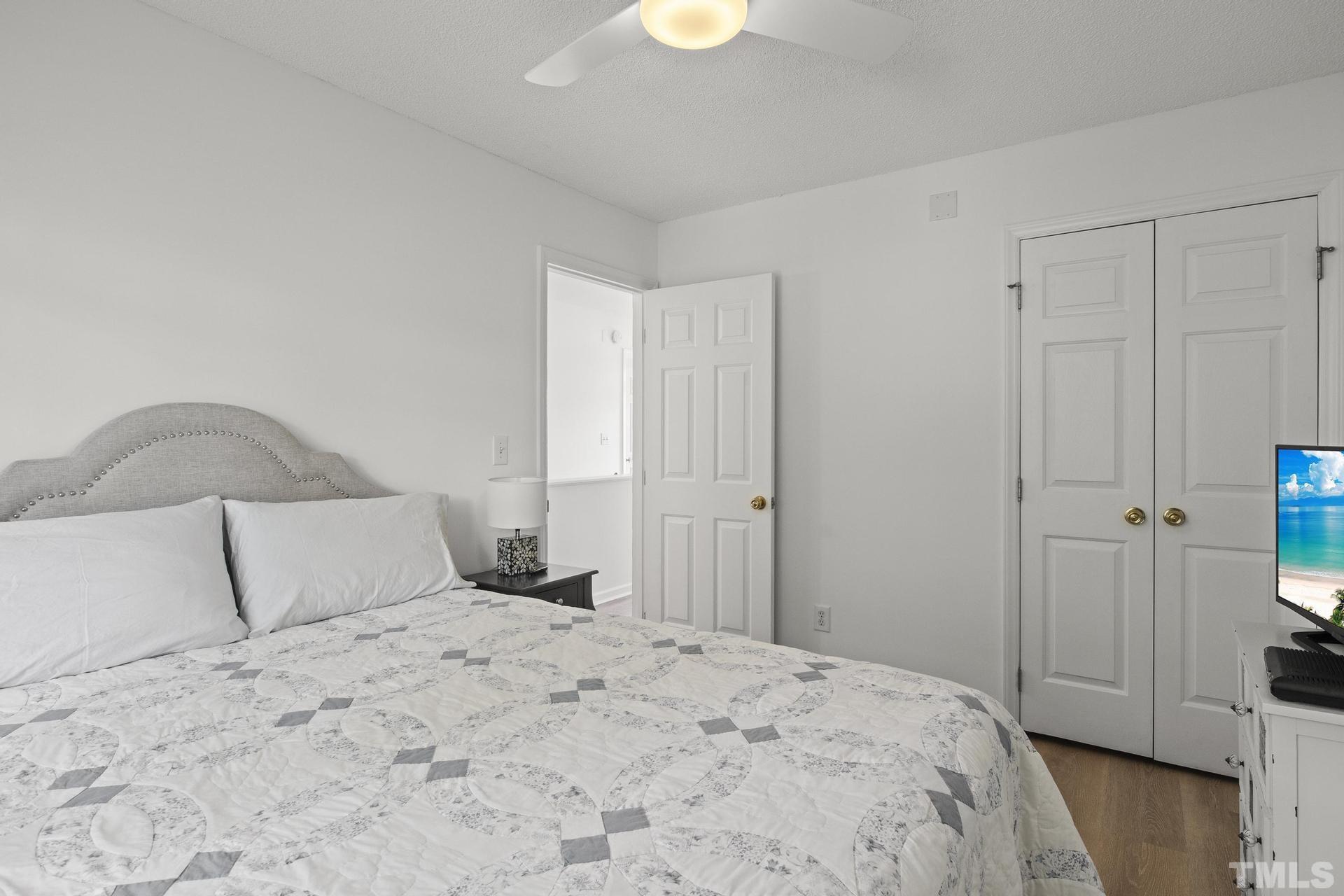 1727 Crag Burn Lane Raleigh, NC 27604 - Photo 25 of 43 a bedroom with a bed and a lamp