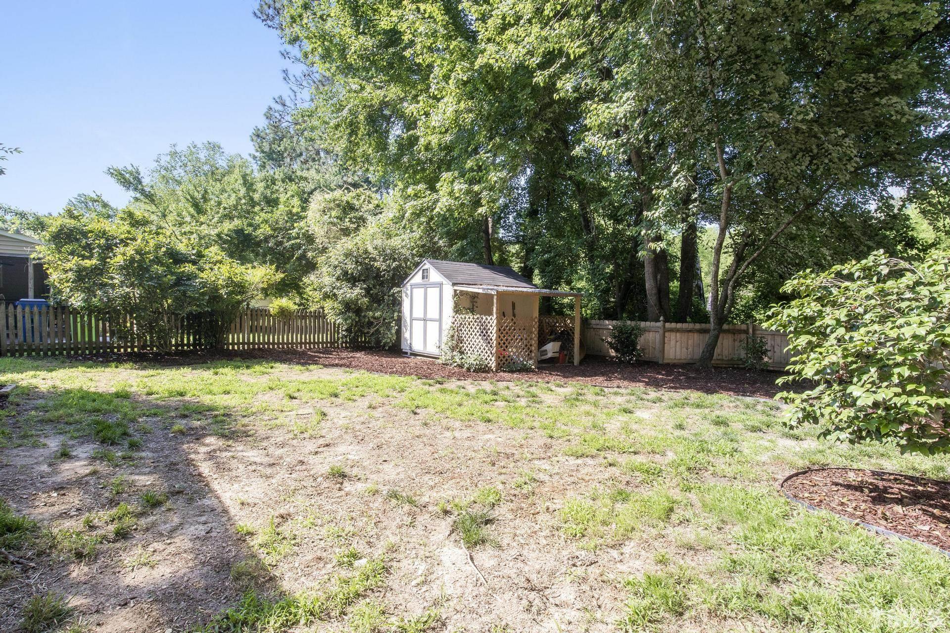 1727 Crag Burn Lane Raleigh, NC 27604 - Photo 30 of 43 a backyard of a house with a tree