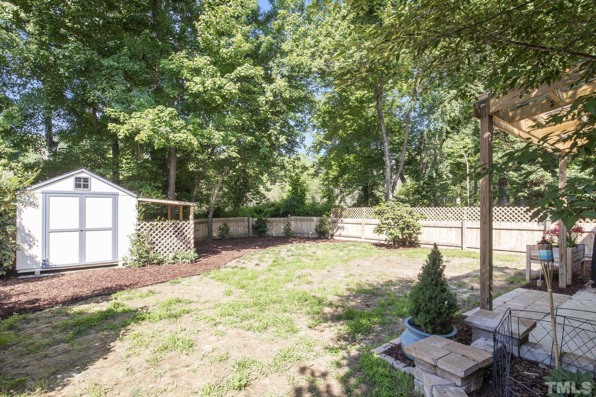 1727 Crag Burn Lane Raleigh, NC 27604 - Photo 31 of 43 a view of backyard with large trees and a small barn