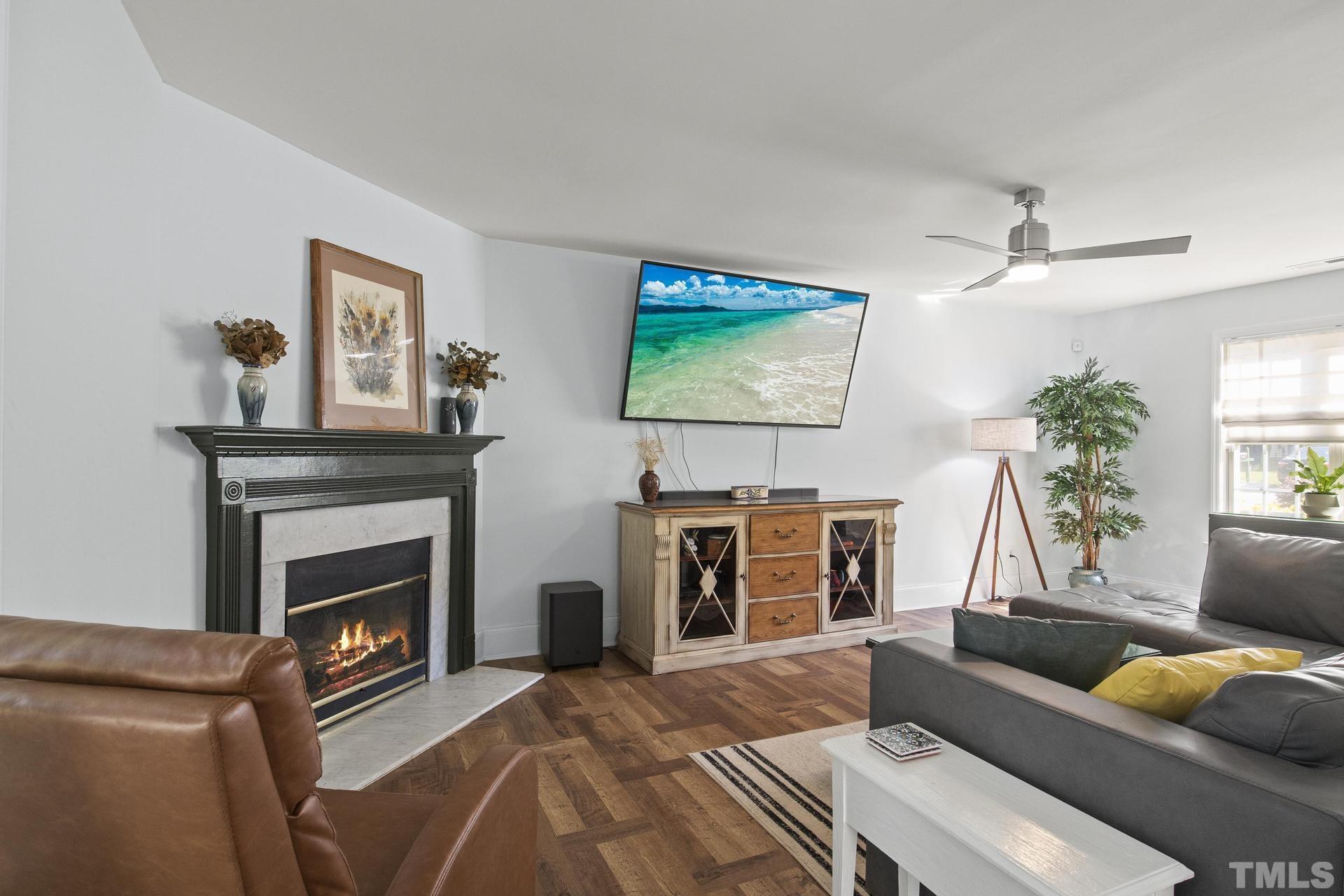 1727 Crag Burn Lane Raleigh, NC 27604 - Photo 4 of 43 a living room with furniture a flat screen tv and a fireplace