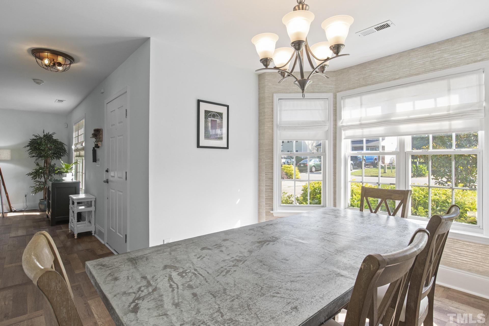1727 Crag Burn Lane Raleigh, NC 27604 - Photo 5 of 43 a view of a dining room with furniture wooden floor and chandelier
