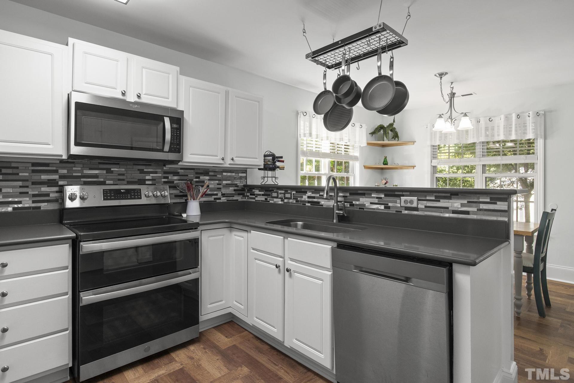 1727 Crag Burn Lane Raleigh, NC 27604 - Photo 9 of 43 a kitchen with a stove and a microwave