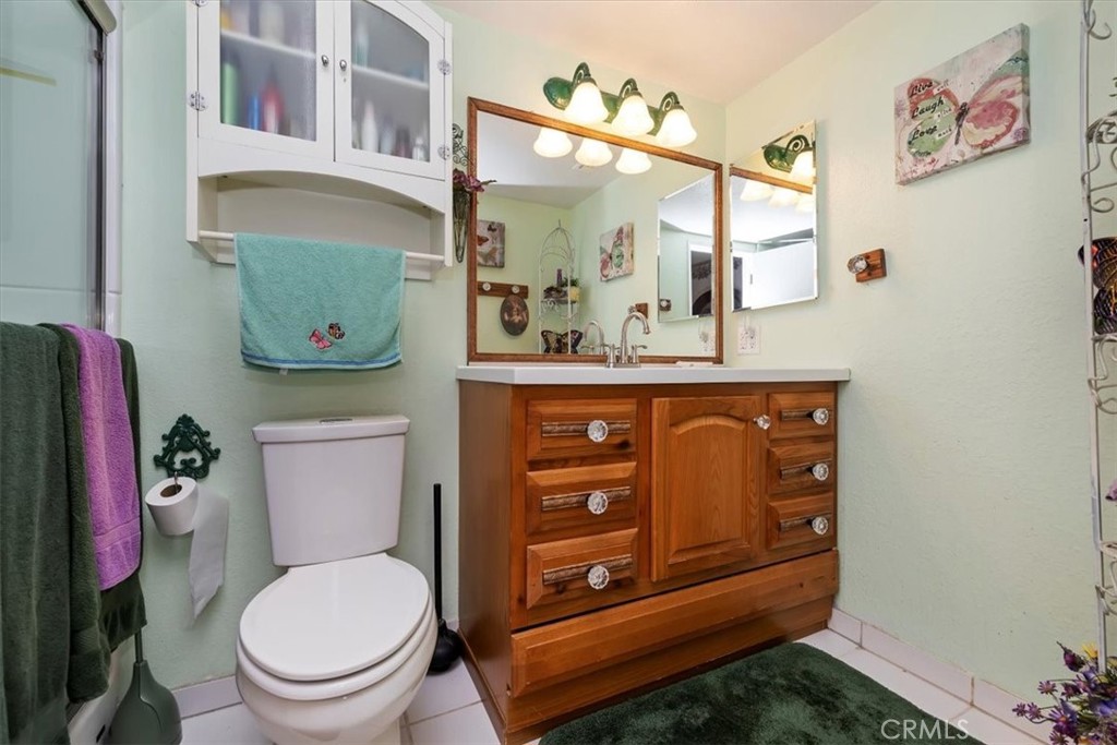 2850 Monroe Street Riverside, CA 92504 - Photo 10 of 23 a bathroom with a toilet a sink and a mirror