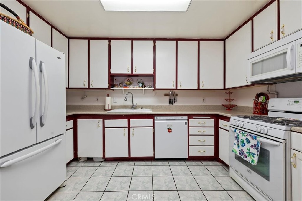 2850 Monroe Street Riverside, CA 92504 - Photo 11 of 23 a kitchen with stainless steel appliances granite countertop a stove a sink and a refrigerator