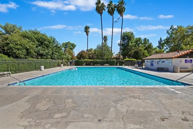 a view of a swimming pool with a yard