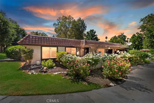 a front view of a house with garden