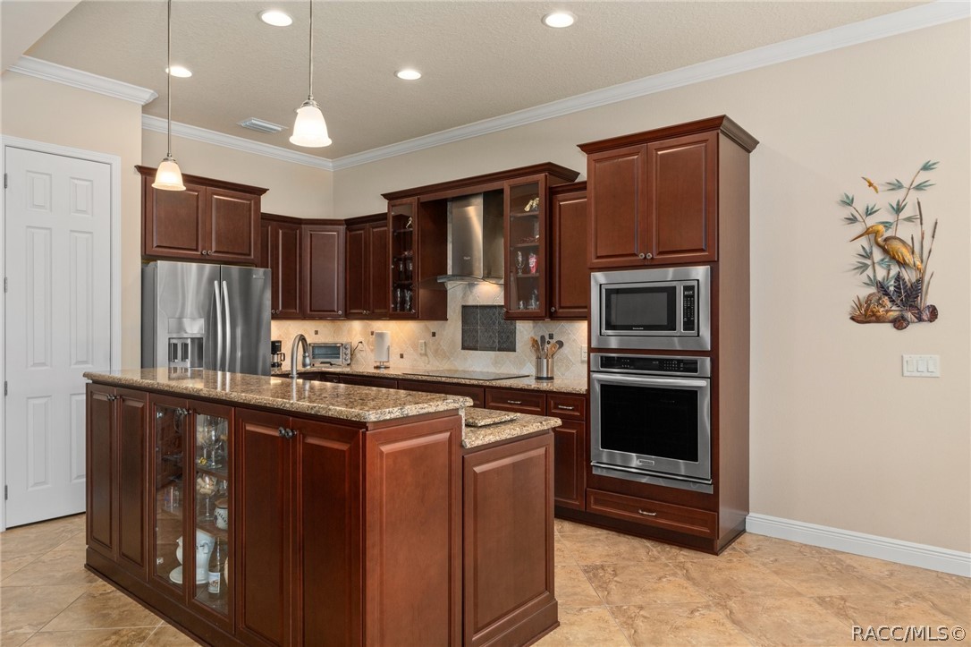 2015 North Rhodes Point Hernando, FL 34442 - Photo 11 of 82 The kitchen features beautiful wood cabinets that add warmth to the home. The door on the left is the Pantry.