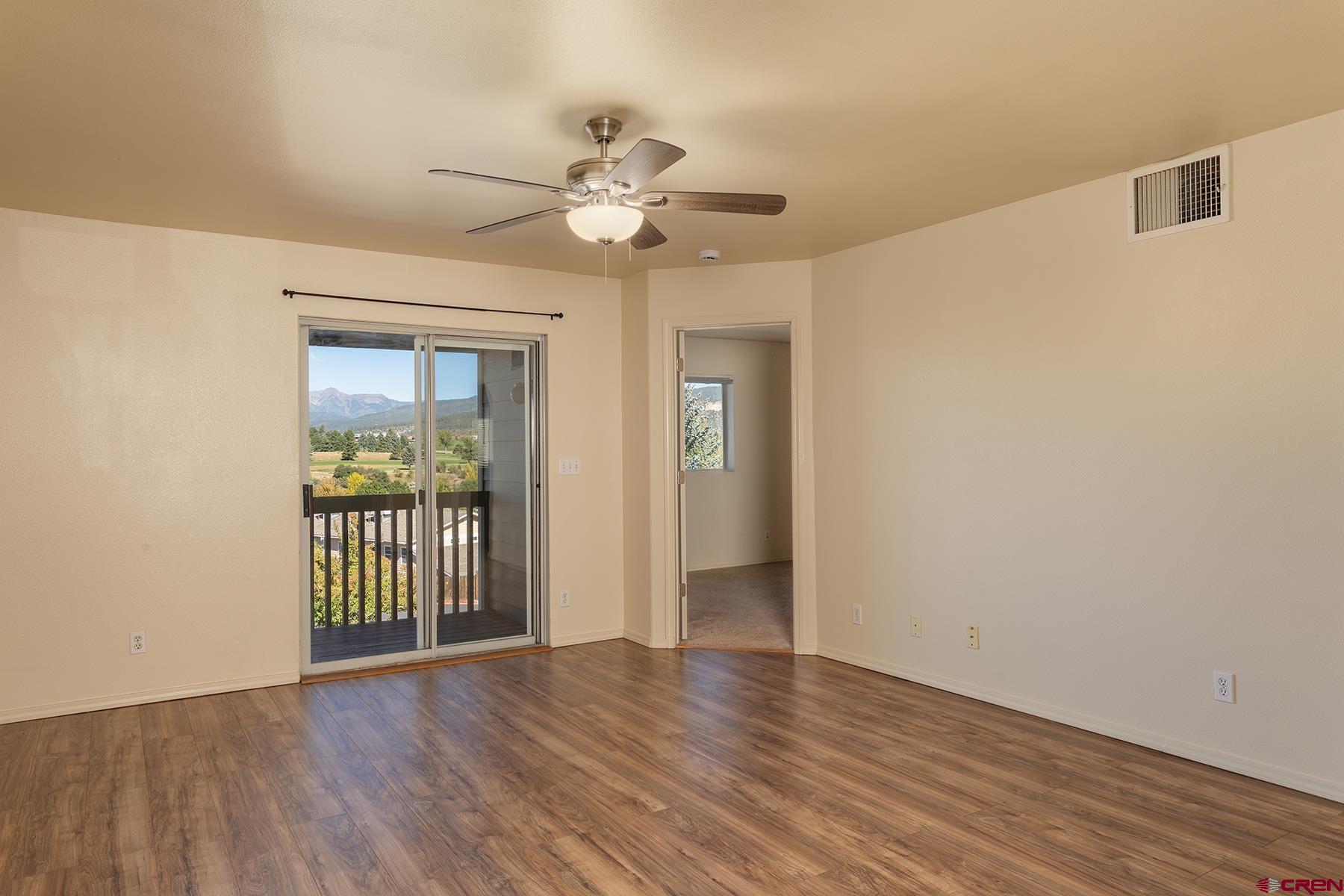 1100 Goeglein Gulch Road, Unit 236 Durango, CO 81301 - Photo 3 of 23 a view of an empty room with wooden floor and a window