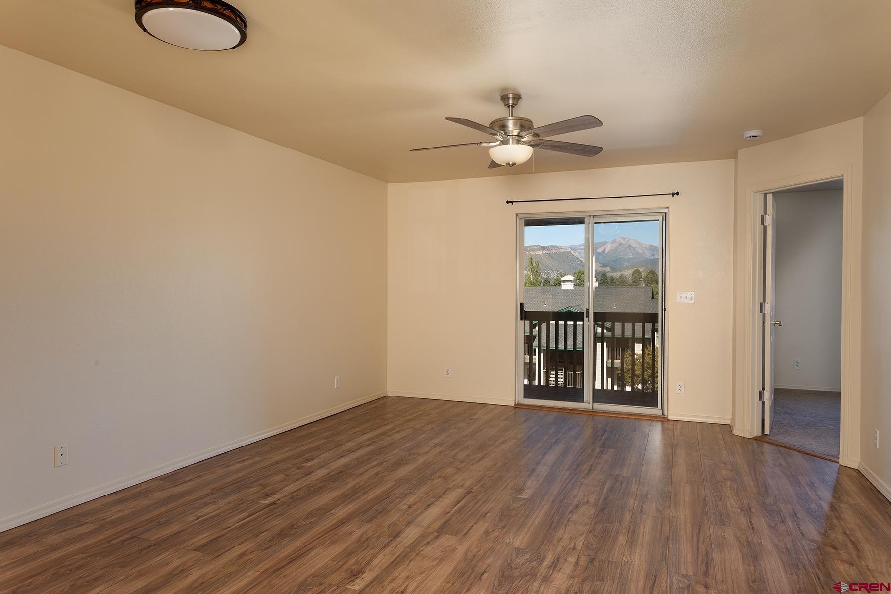 1100 Goeglein Gulch Road, Unit 236 Durango, CO 81301 - Photo 4 of 23 a view of an empty room with wooden floor and a window
