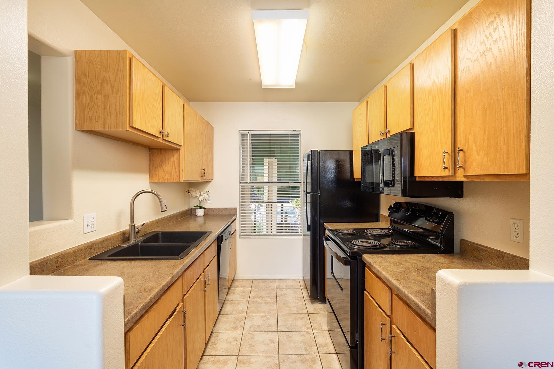 1100 Goeglein Gulch Road, Unit 236 Durango, CO 81301 - Photo 5 of 23 a kitchen with stainless steel appliances granite countertop a sink a stove and a refrigerator