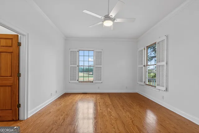 a view of a livingroom with furniture a fireplace and window