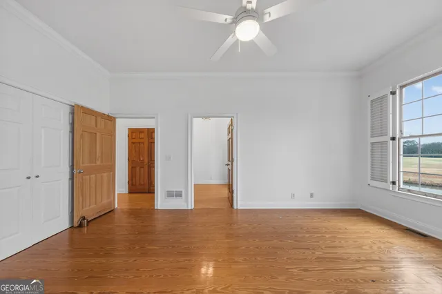 a large kitchen with cabinets wooden floor and stainless steel appliances